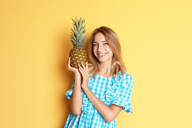 Photo of Happy slim woman with pineapple on color background. Weight loss diet