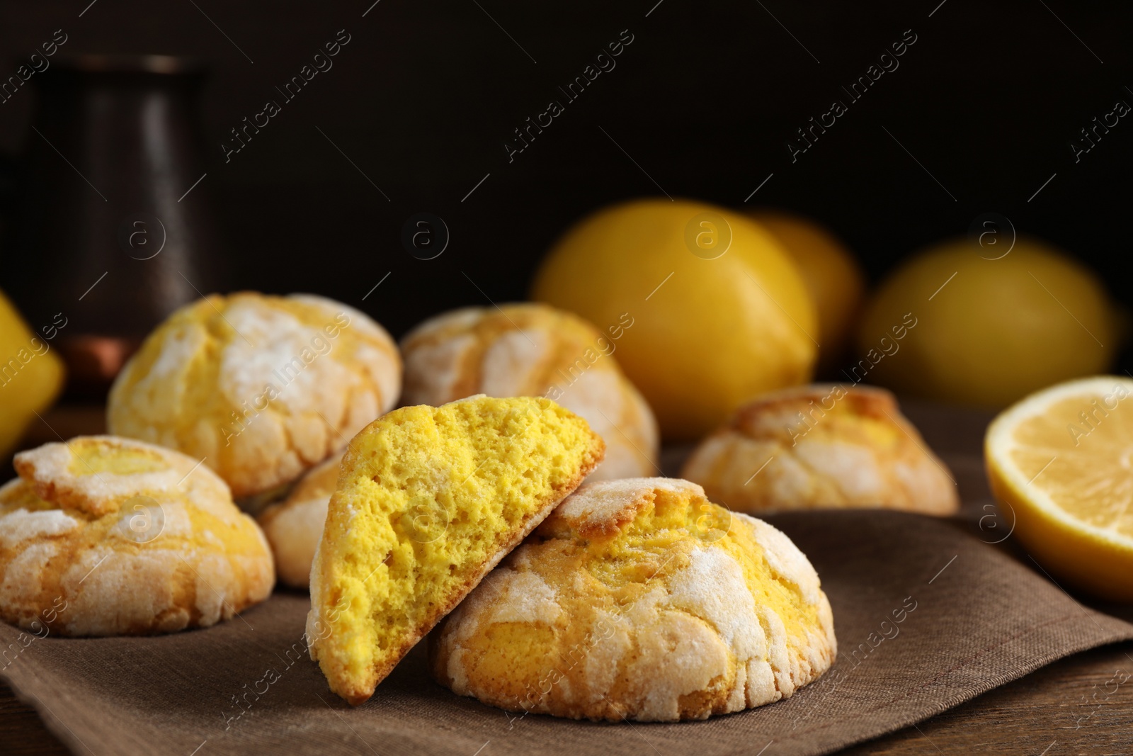 Photo of Delicious lemon cookies on wooden table, closeup