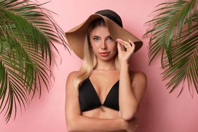 Photo of Pretty young woman wearing stylish bikini on pink background