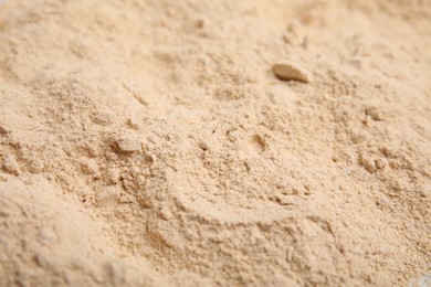 Photo of Pile of sesame flour as background, closeup