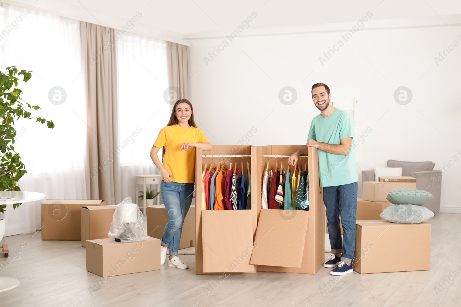 Photo of Young couple near wardrobe boxes at home