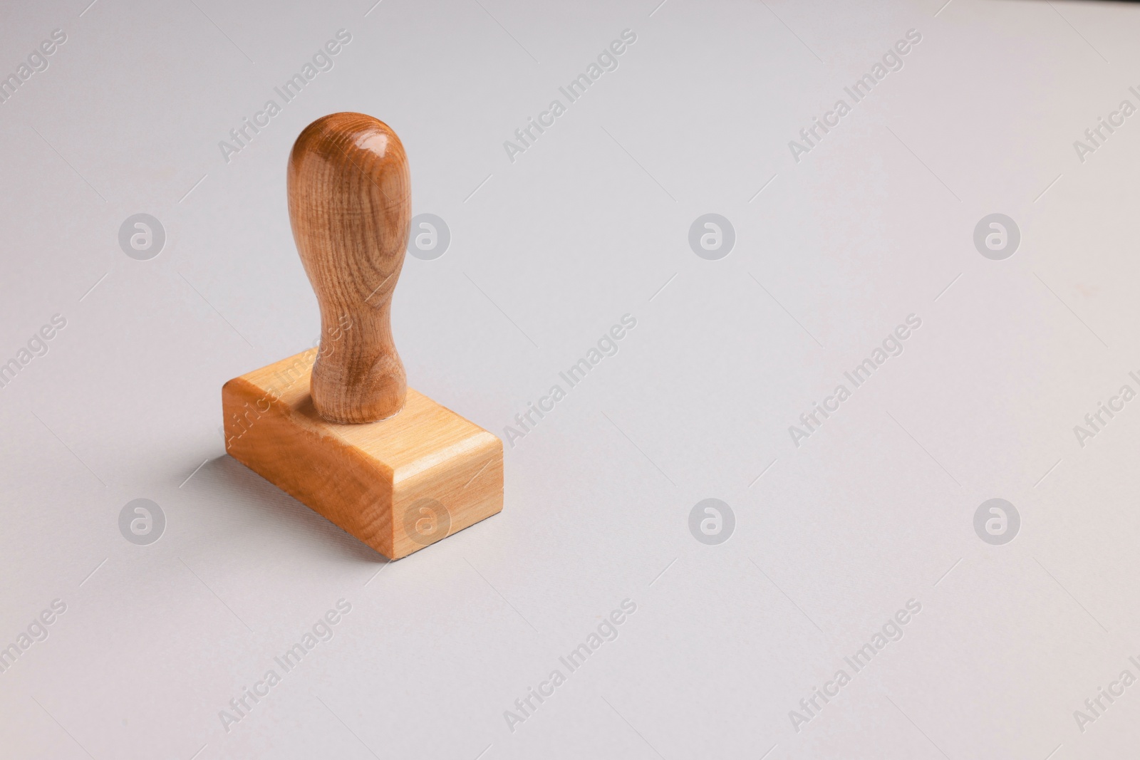 Photo of One wooden stamp tool on light grey background, space for text