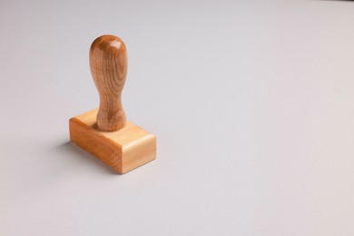 Photo of One wooden stamp tool on light grey background, space for text