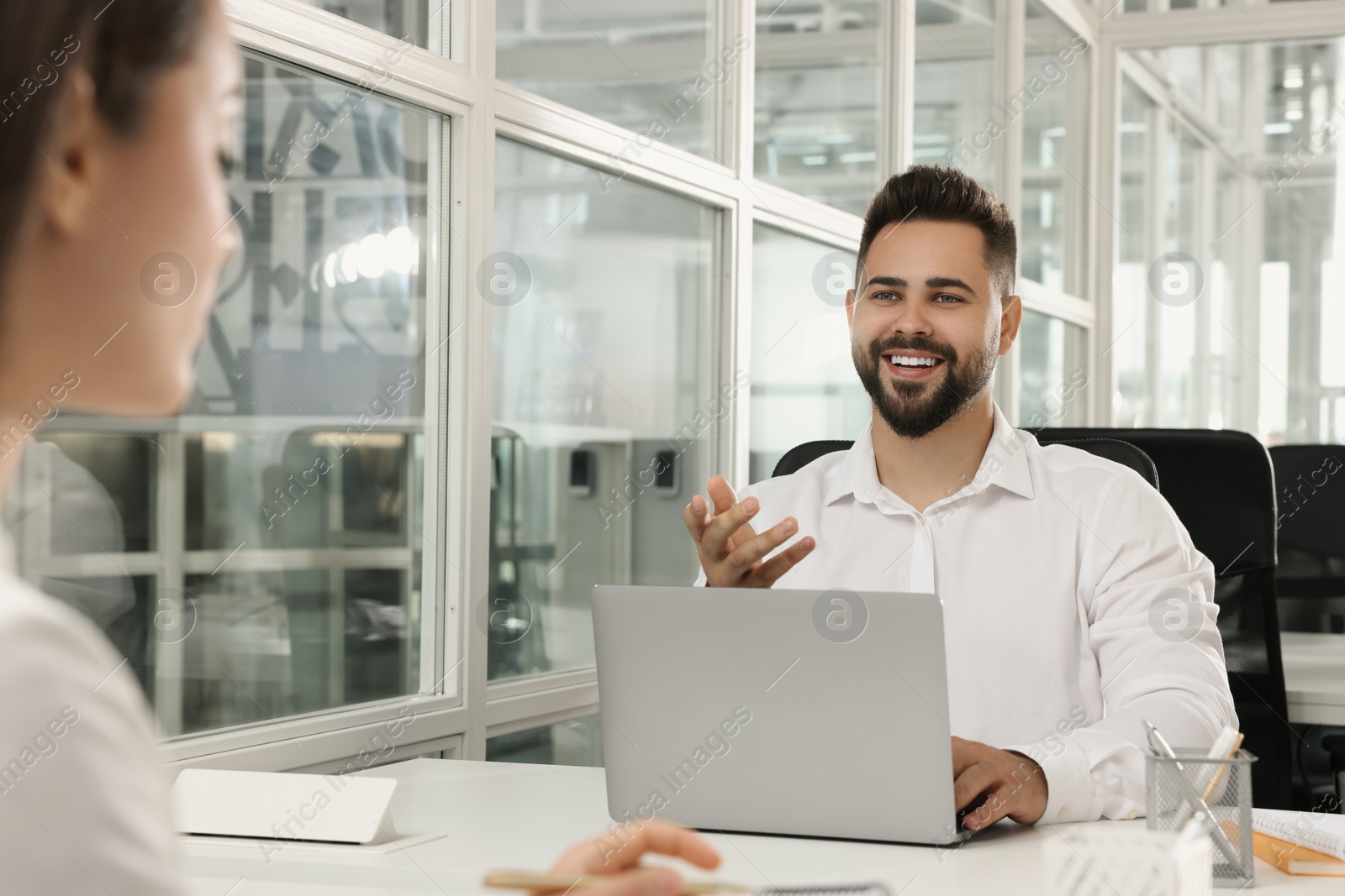 Photo of Colleagues working together in open plan office