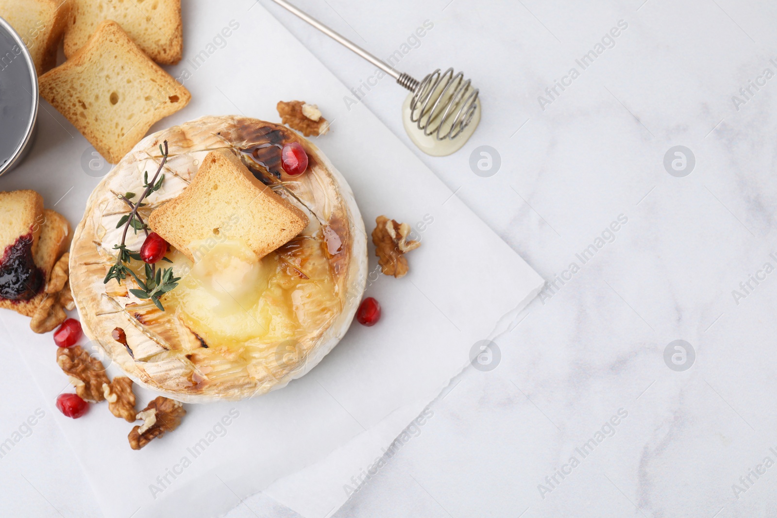 Photo of Flat lay composition with tasty baked camembert on white marble table. Space for text