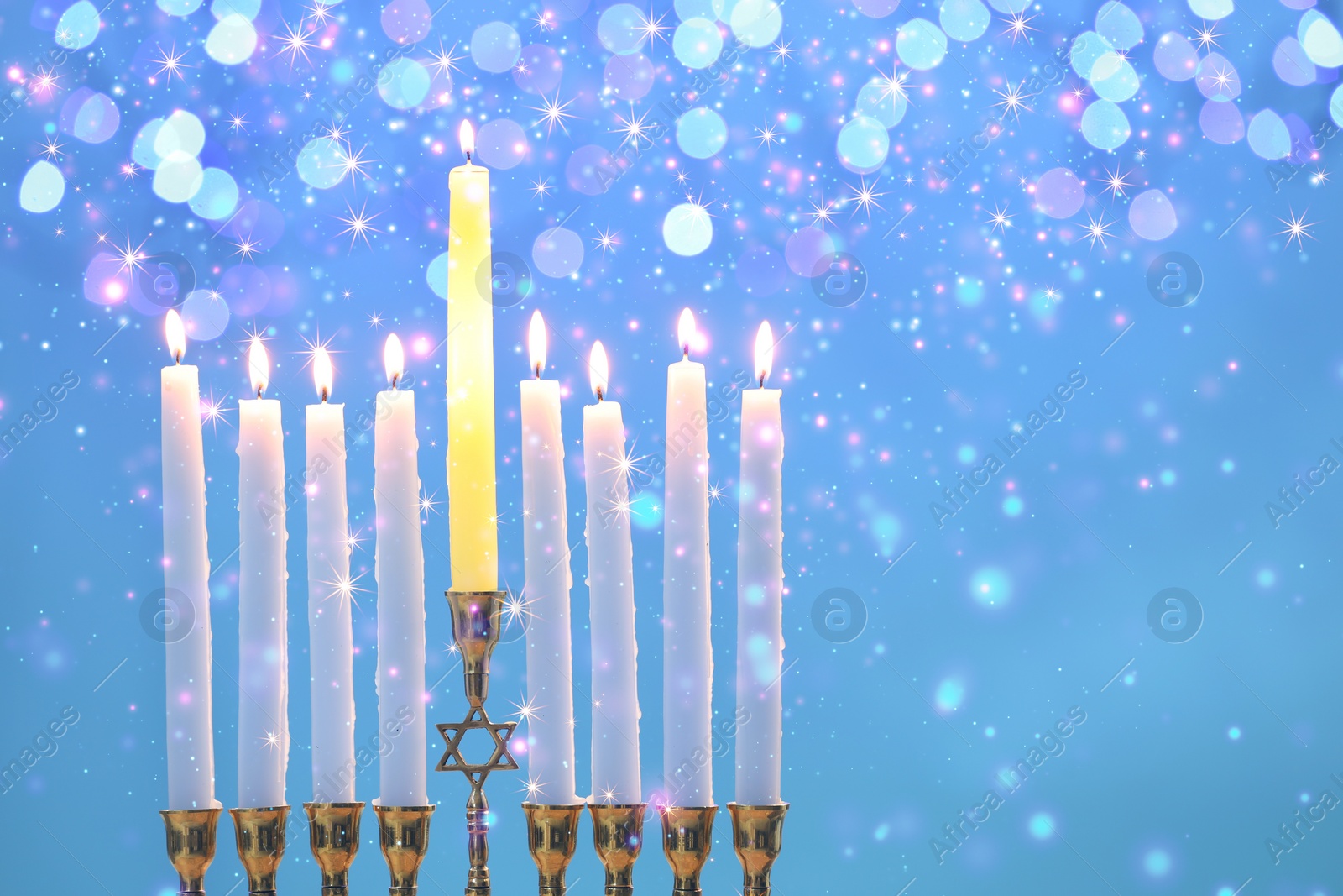 Image of Hanukkah celebration. Menorah with burning candles on light blue background with blurred lights, closeup. Space for text