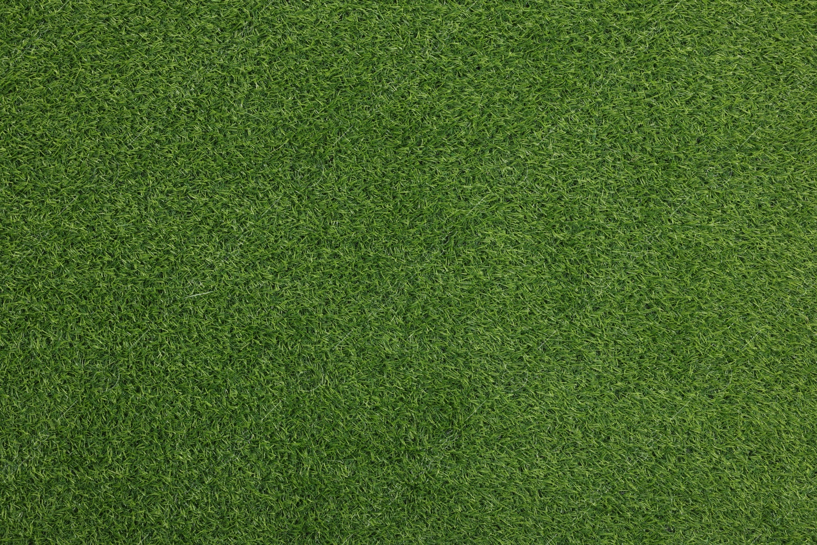 Photo of Green artificial grass as background, top view