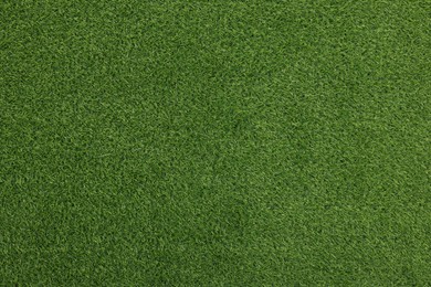 Photo of Green artificial grass as background, top view