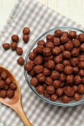 Tasty corn balls and spoon on white table, top view. Healthy breakfast cereal