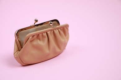 Stylish beige leather purse on pink background, space for text