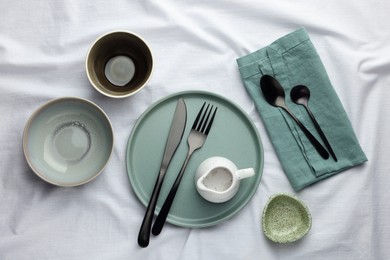 Stylish empty dishware and cutlery on table, flat lay