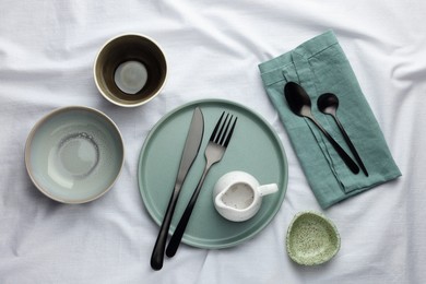 Photo of Stylish empty dishware and cutlery on table, flat lay