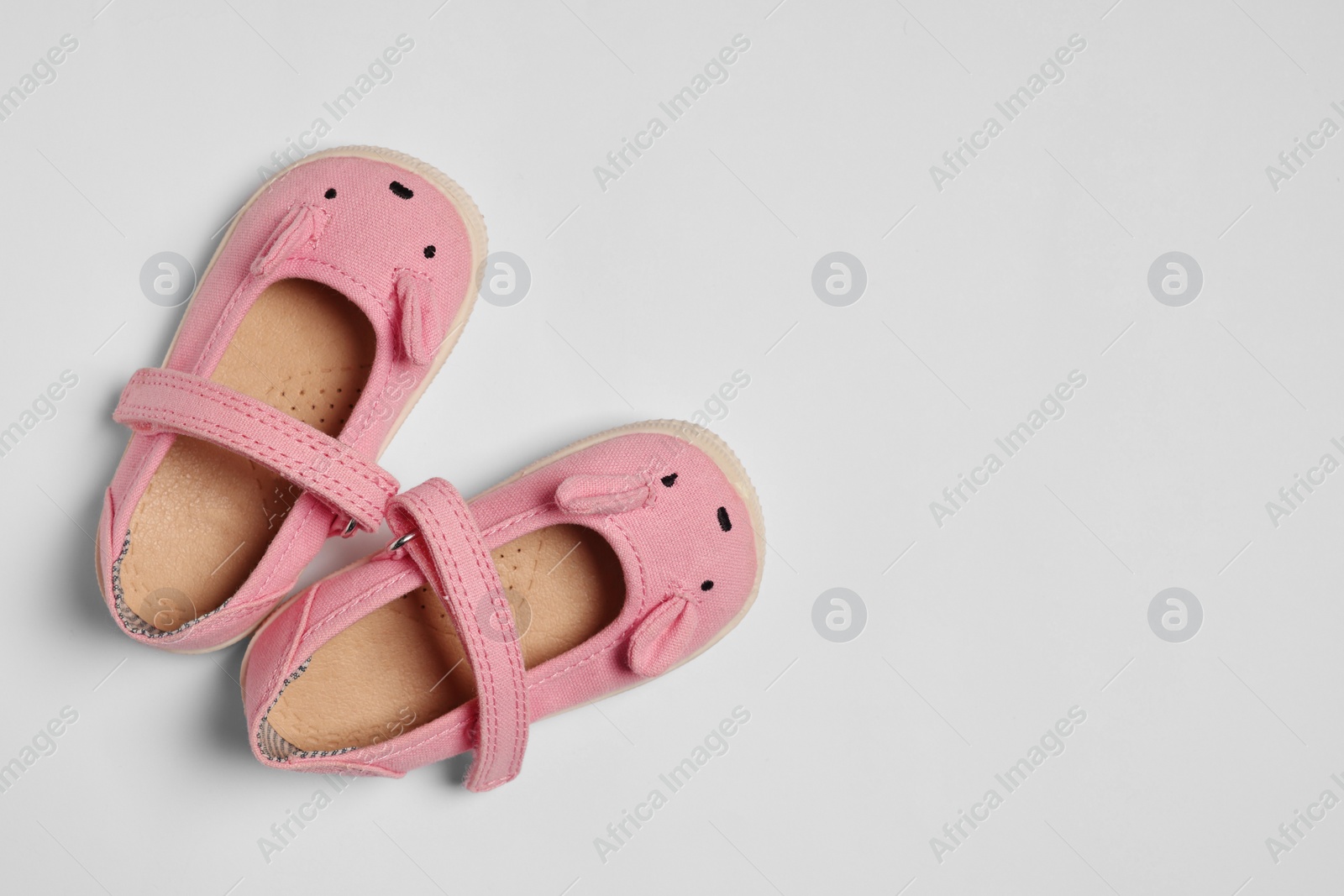 Photo of Cute baby shoes on white background, flat lay. Space for text