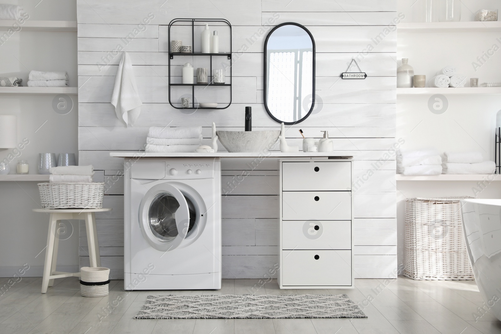 Photo of Stylish bathroom interior with modern washing machine