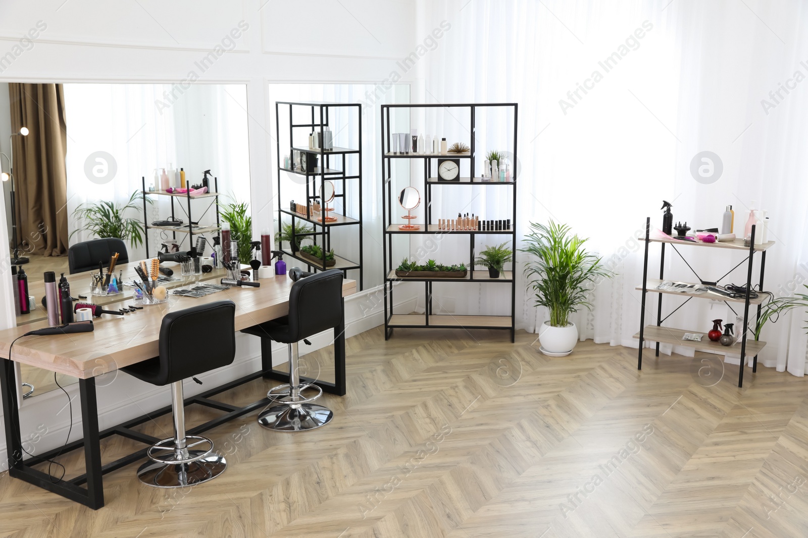 Photo of Stylish beauty salon interior with hairdresser's workplace