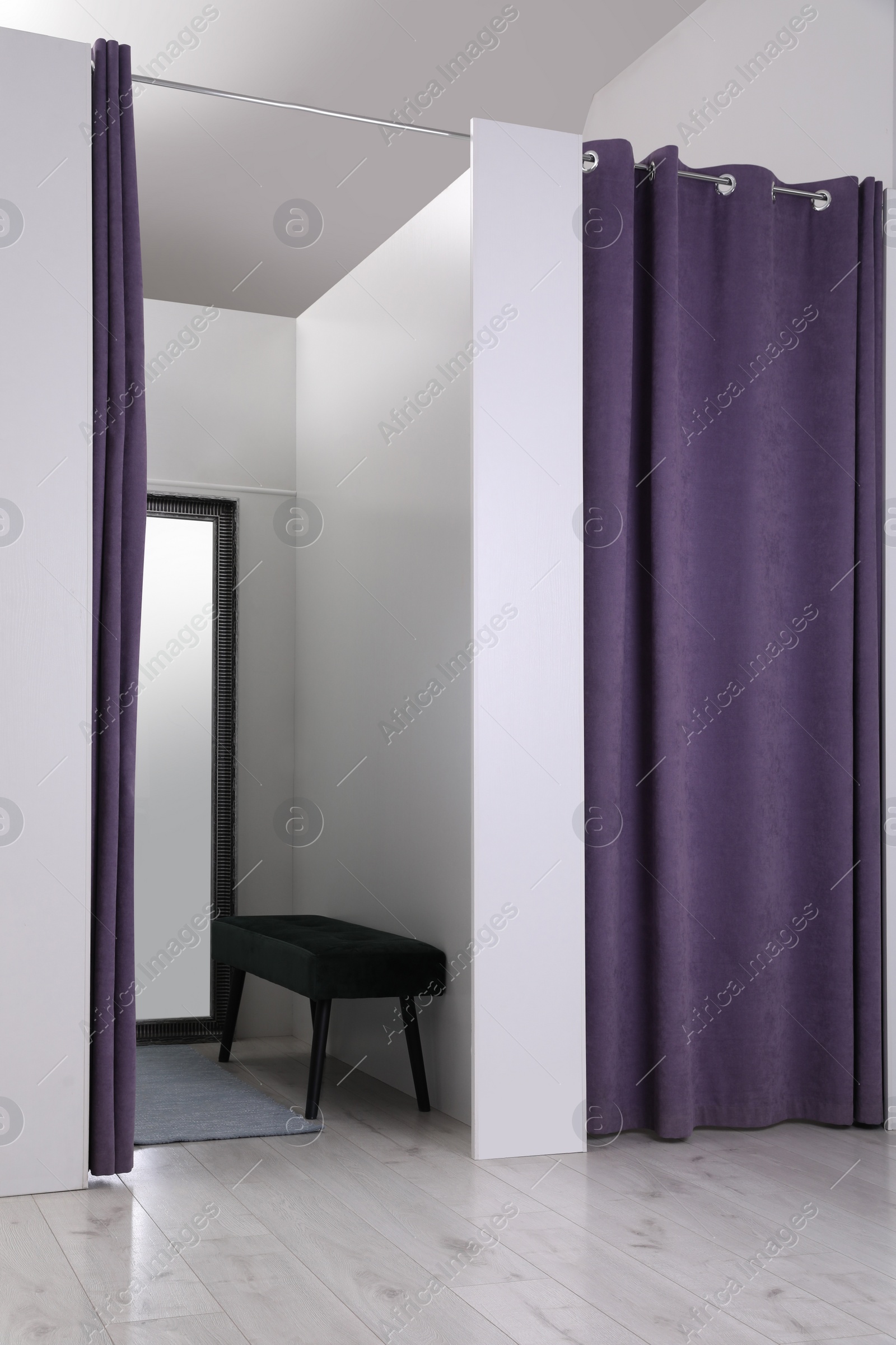 Photo of Empty dressing room in fashion store. Stylish interior