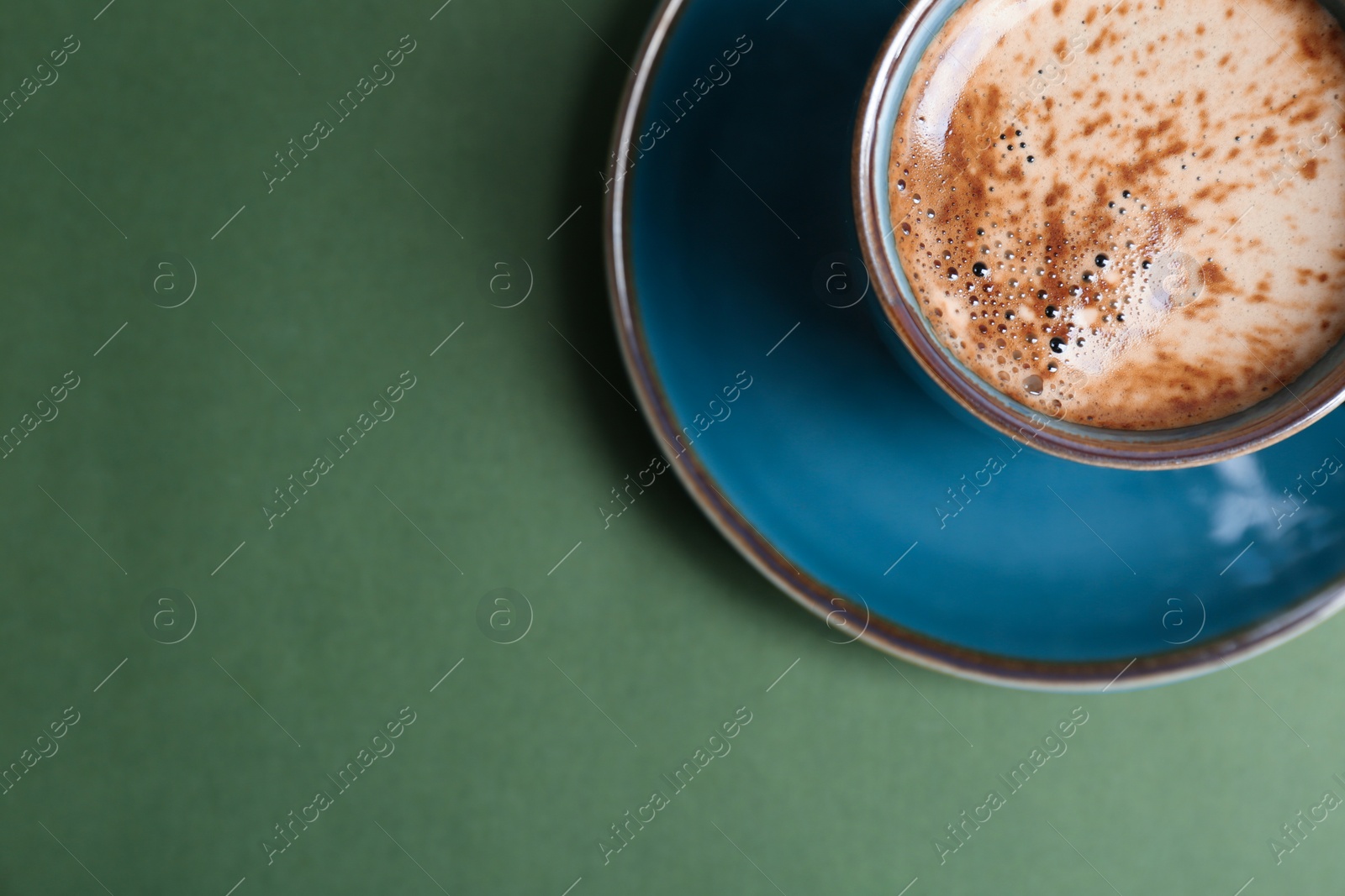 Photo of Cup of aromatic hot coffee on color background, top view
