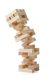 Photo of Jenga tower made of wooden blocks falling on white background