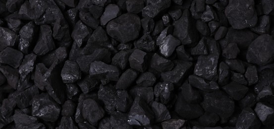 Photo of Pieces of black coal as background, top view