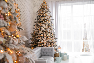 Photo of Beautiful interior of living room with decorated Christmas trees