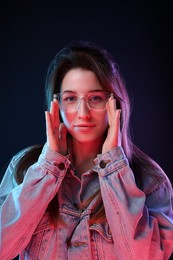 Photo of Portrait of beautiful young woman in glasses on color background