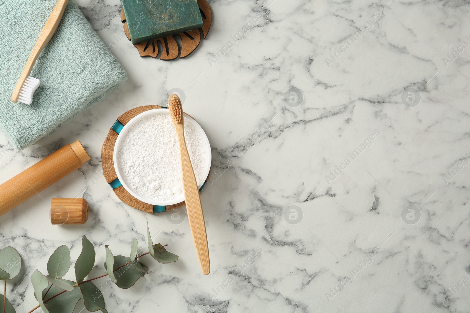 Photo of Flat lay composition with tooth powder and brushes on white marble table. Space for text