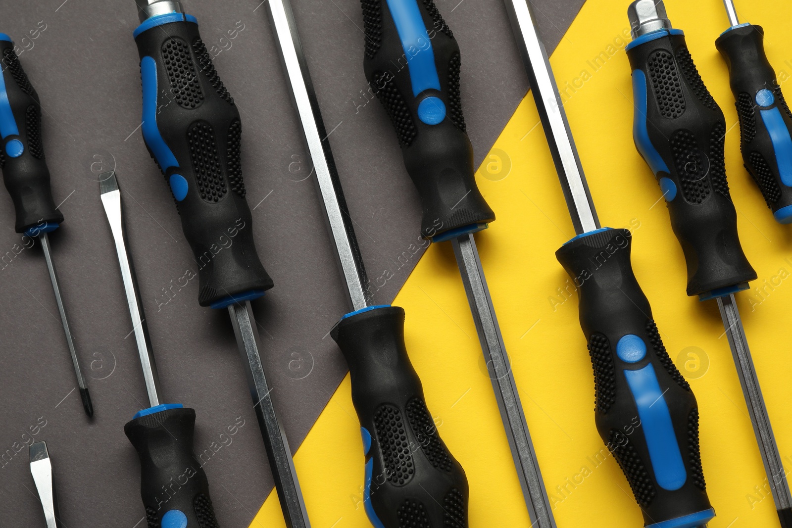 Photo of Set of screwdrivers on color background, flat lay