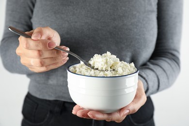 Woman with bowl of cottage cheese, closeup