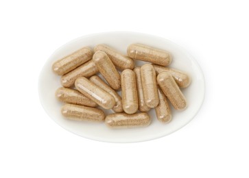 Vitamin capsules in bowl isolated on white, top view. Health supplement