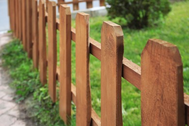 Photo of Small wooden fence on sunny day outdoors, closeup