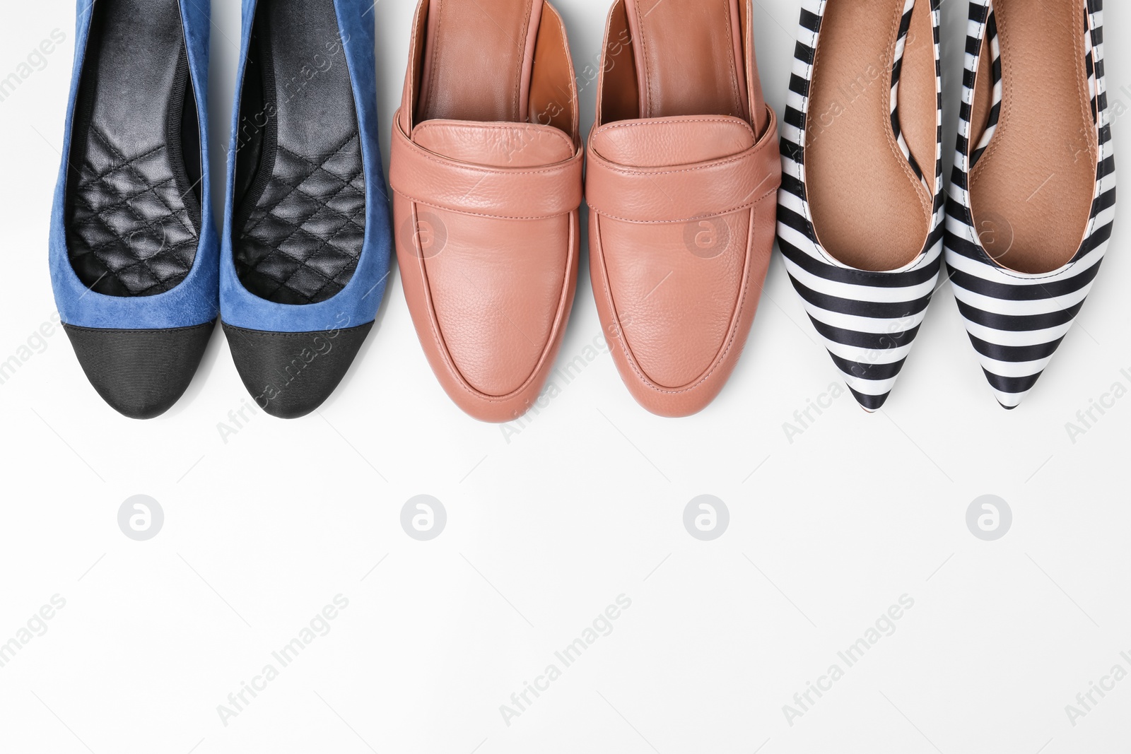 Photo of Different female shoes on white background, top view