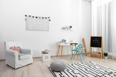 Photo of Modern child room interior with stylish furniture