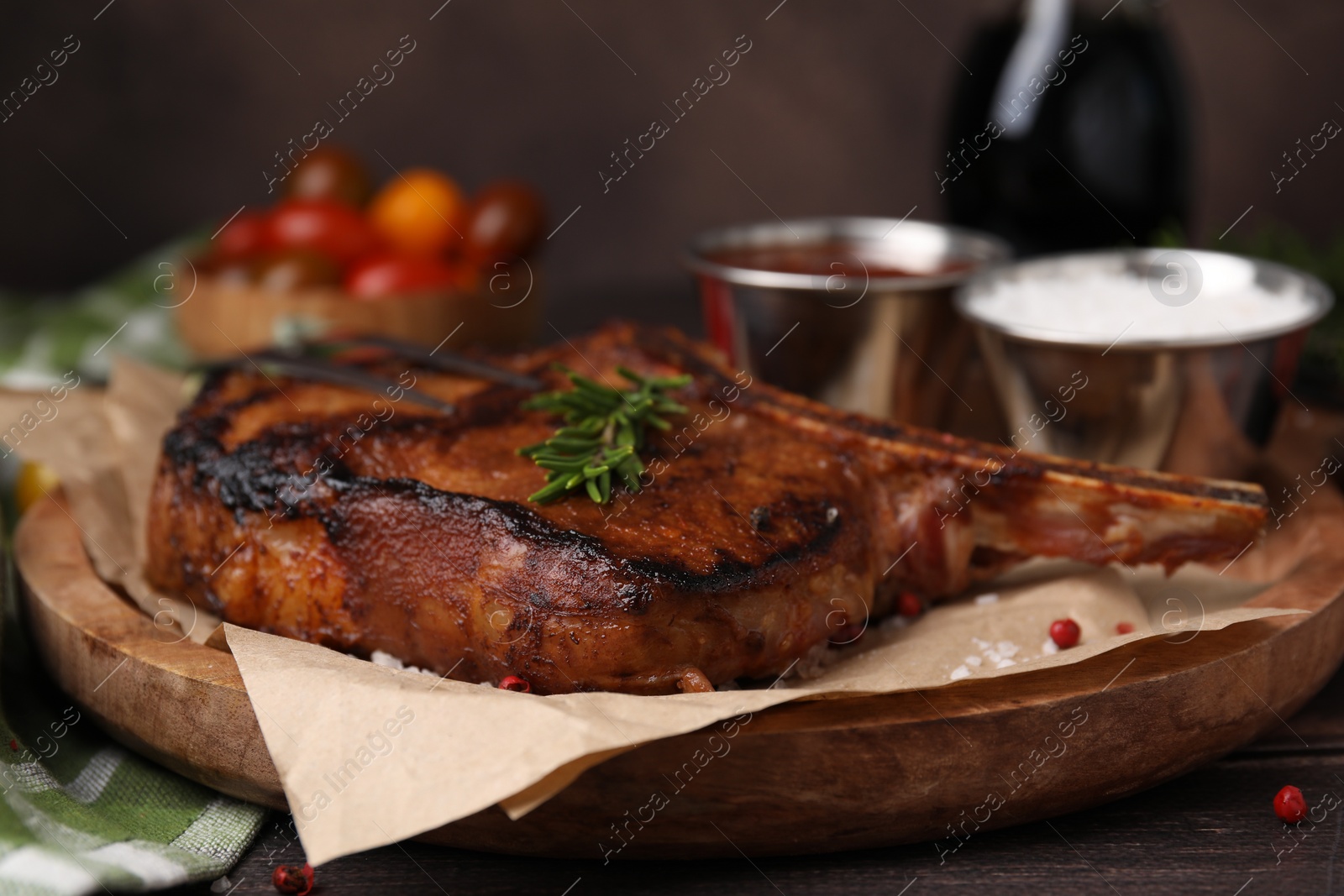 Photo of Tasty marinated meat, rosemary and spices on wooden table, closeup