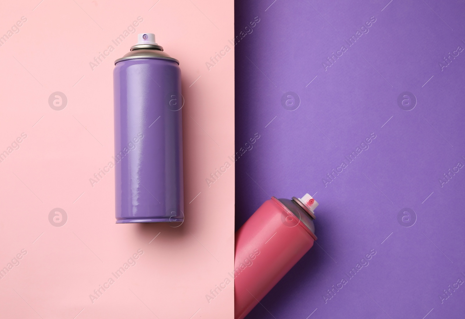 Photo of Cans of different spray paints on color background, flat lay with space for text. Graffiti supplies