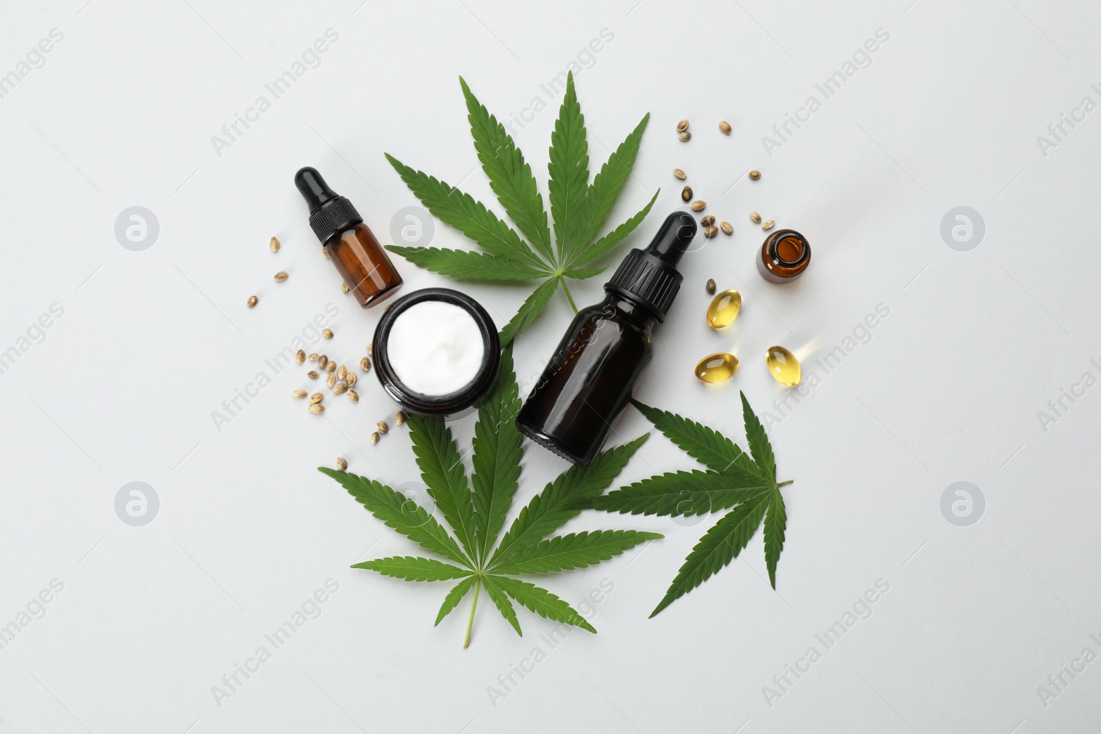 Photo of Flat lay composition with hemp leaves, CBD oil and THC tincture on light background