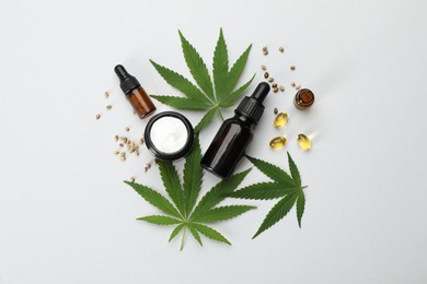 Photo of Flat lay composition with hemp leaves, CBD oil and THC tincture on light background
