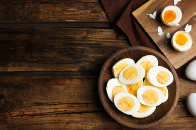 Photo of Tasty boiled chicken eggs on wooden table, flat lay. Space for text