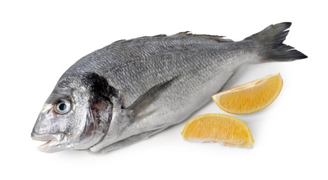 Raw dorado fish and lemon wedges isolated on white