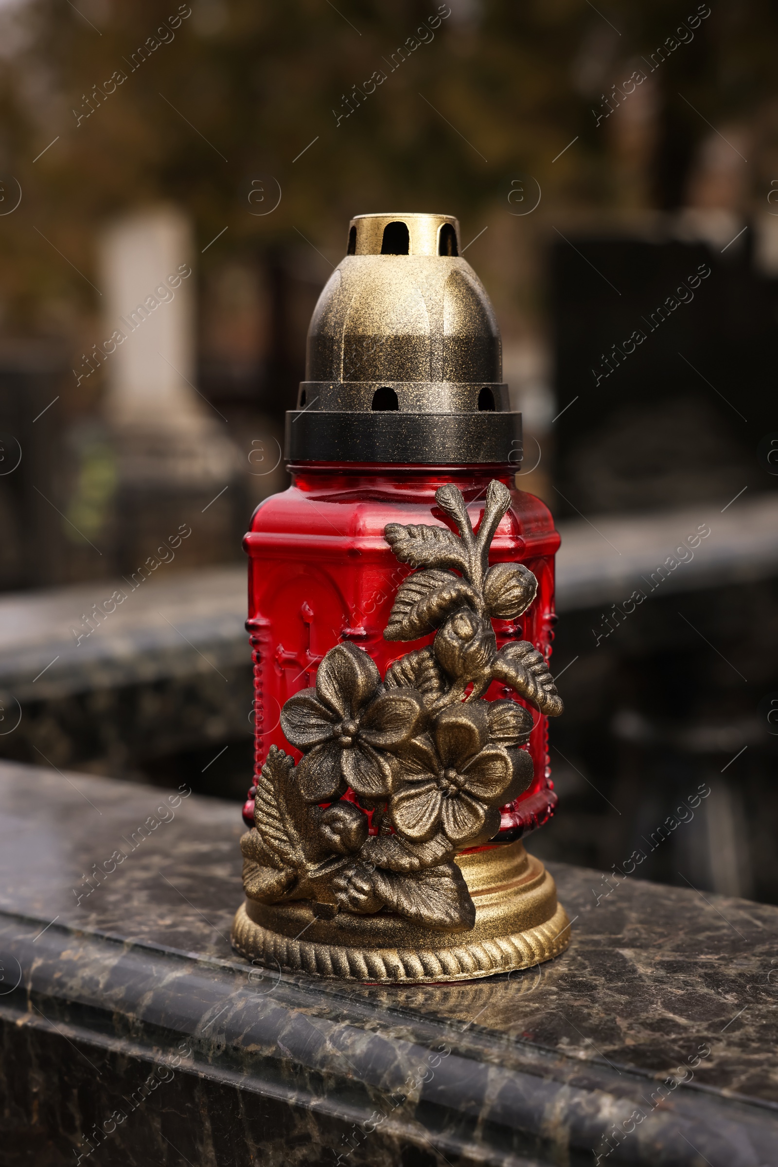 Photo of Grave lantern on granite surface at cemetery