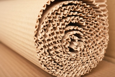 Roll of brown corrugated cardboard, closeup. Recyclable material