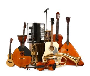 Photo of Set of different musical instruments and microphone on white background