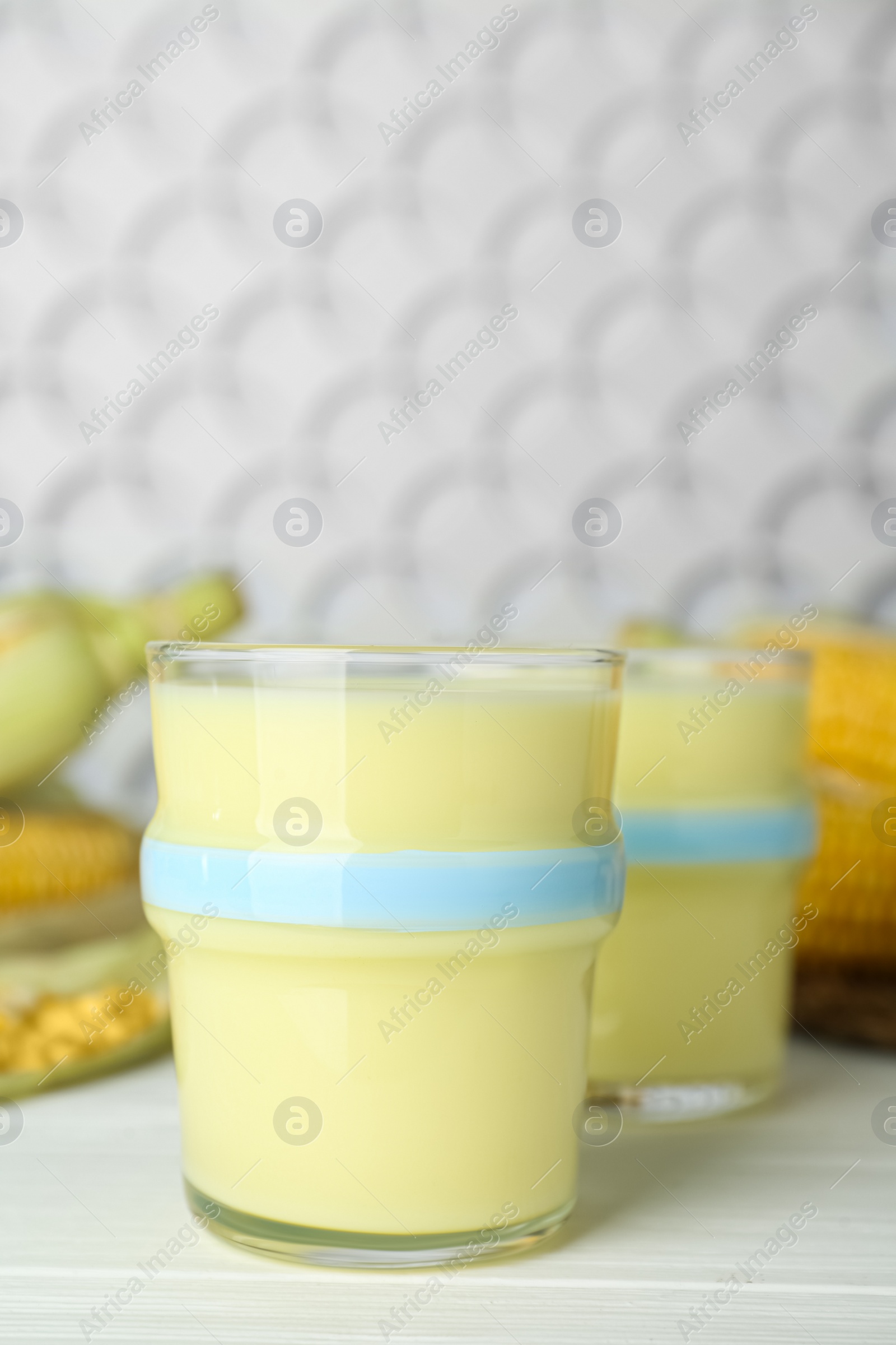 Photo of Freshly made corn milk on white wooden table