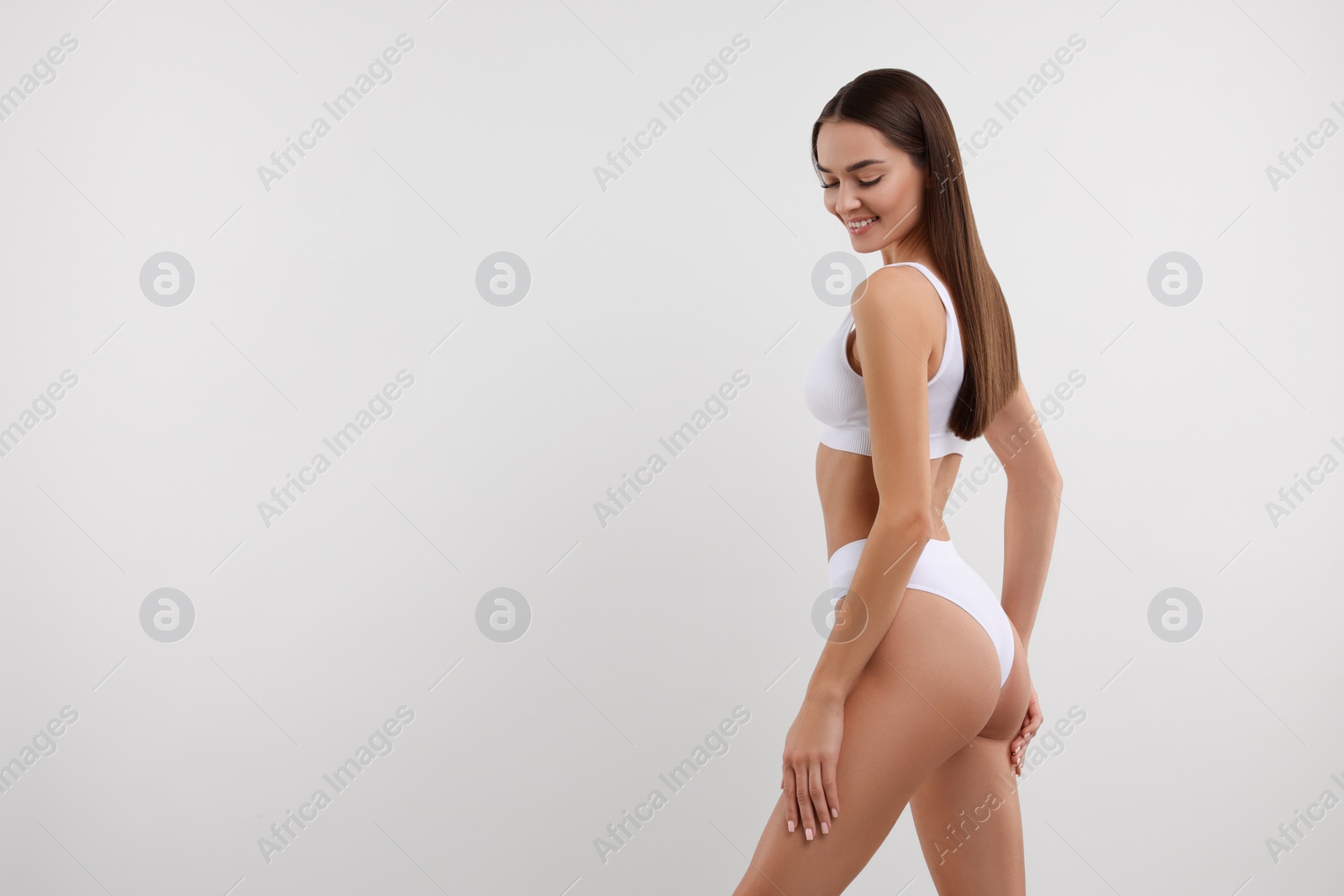 Photo of Young woman in stylish bikini on white background. Space for text