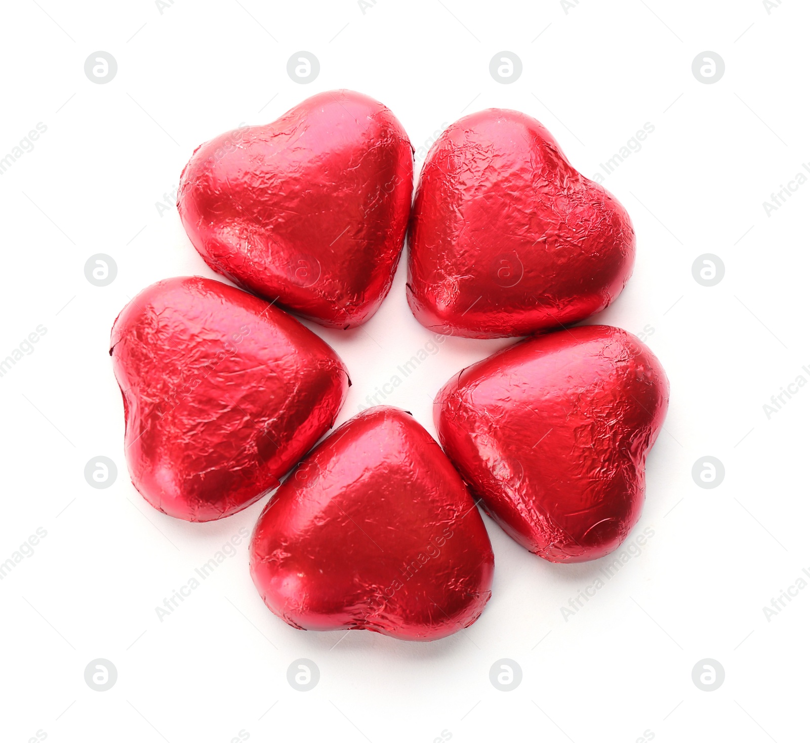 Photo of Heart shaped chocolate candies in red foil on white background, top view