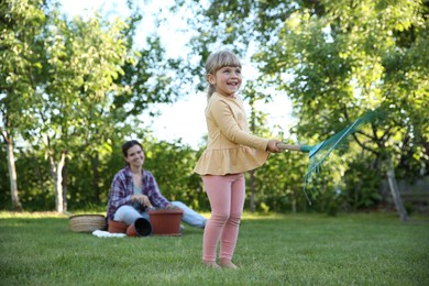 Mother and her daughter working together in garden