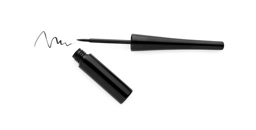 Photo of Black eyeliner and stroke on white background, top view. Makeup product