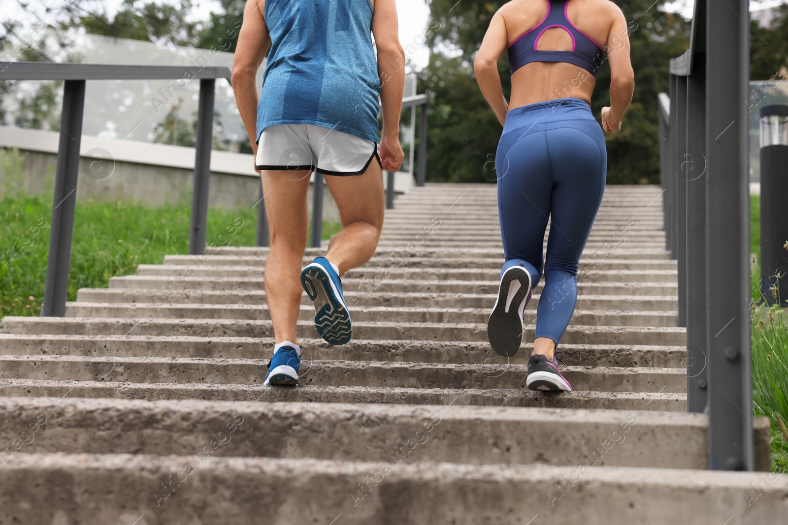 Photo of Healthy lifestyle. Couple running up stairs outdoors, closeup