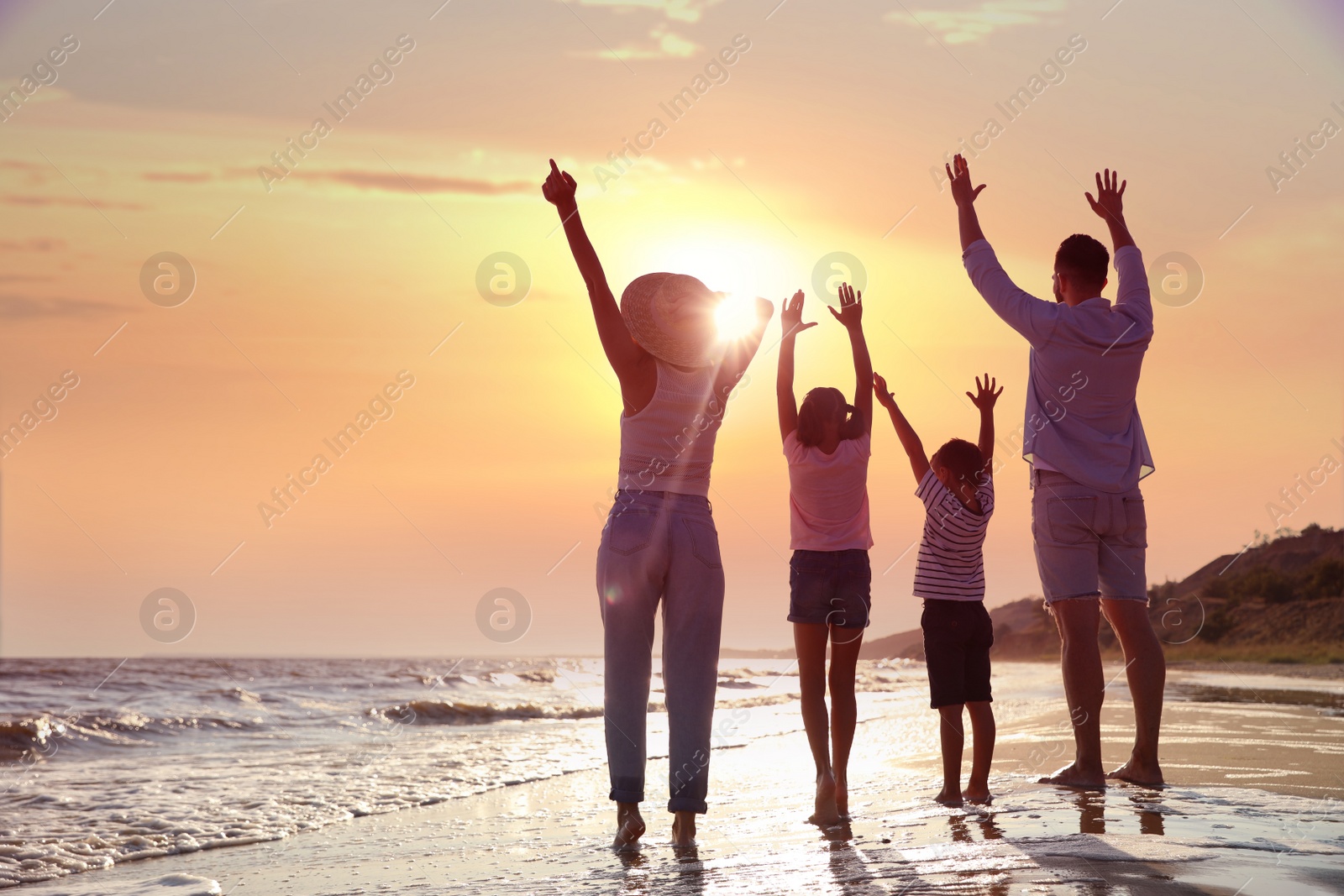 Photo of Family on sandy beach near sea. Summer vacation