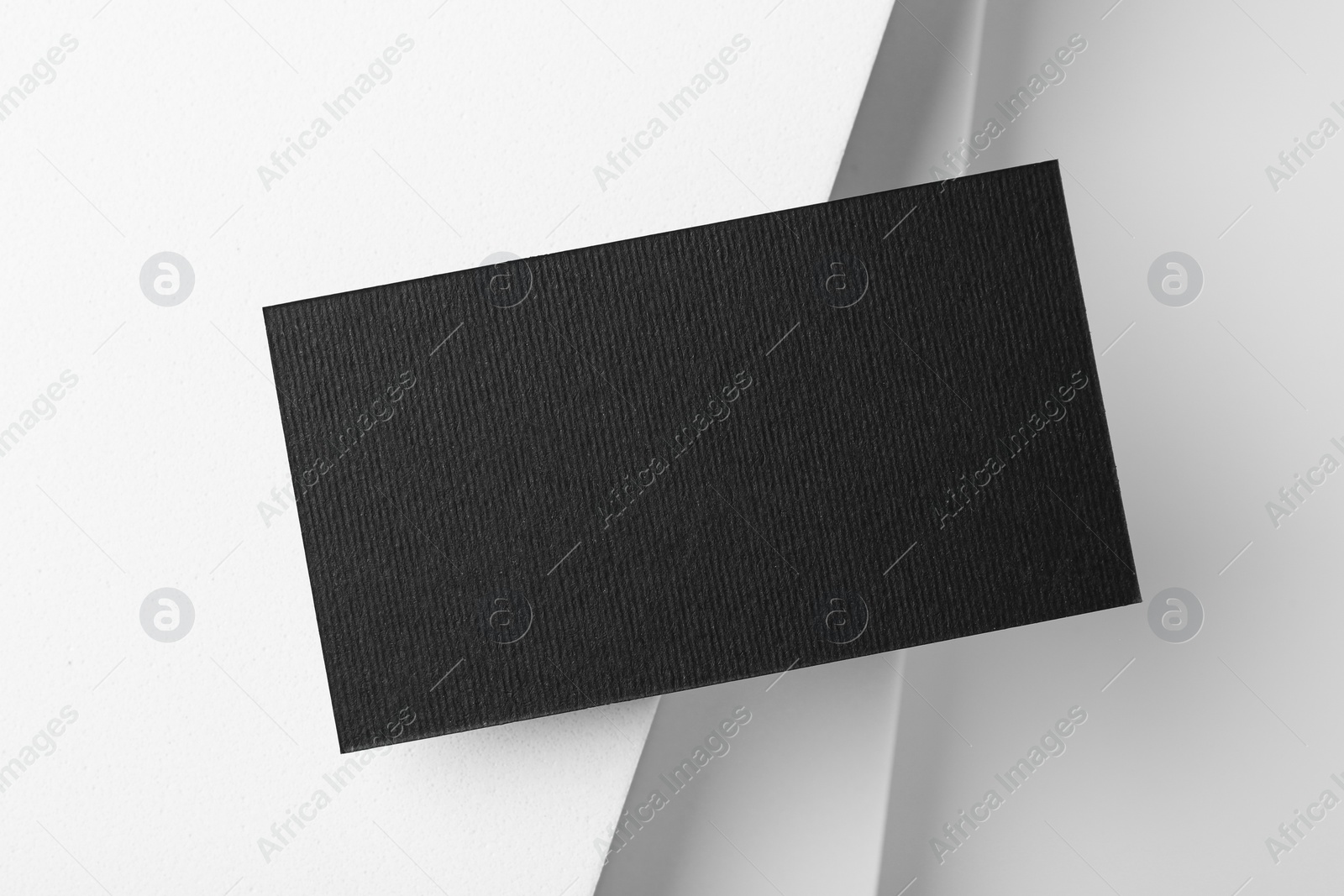 Photo of Blank black business card on light background, top view. Mockup for design