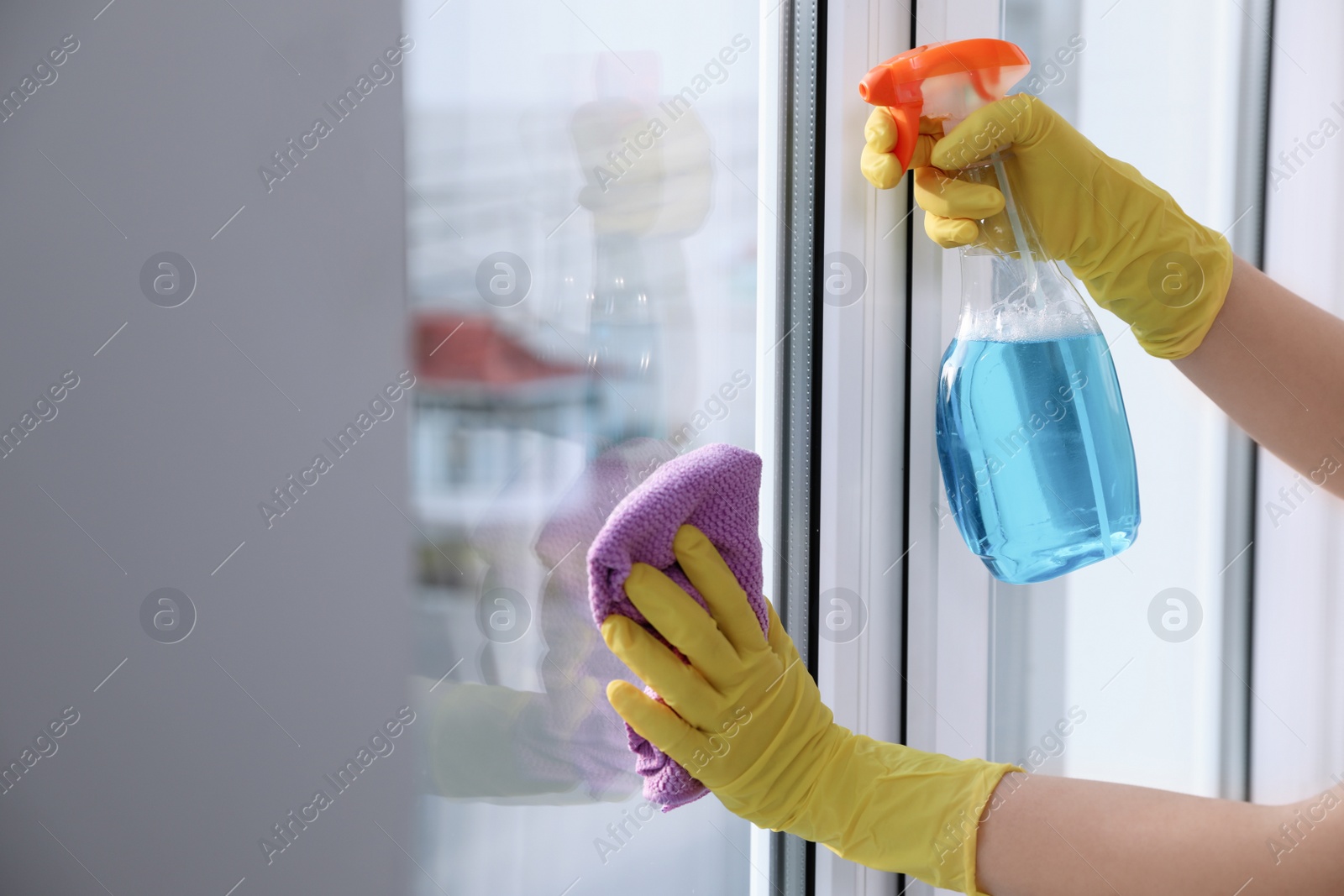 Photo of Woman cleaning window at home, closeup. Household chores